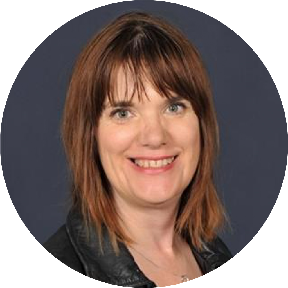 A lady with shoulder-length reddish-brown hair, green eyes, and black leather jacket.