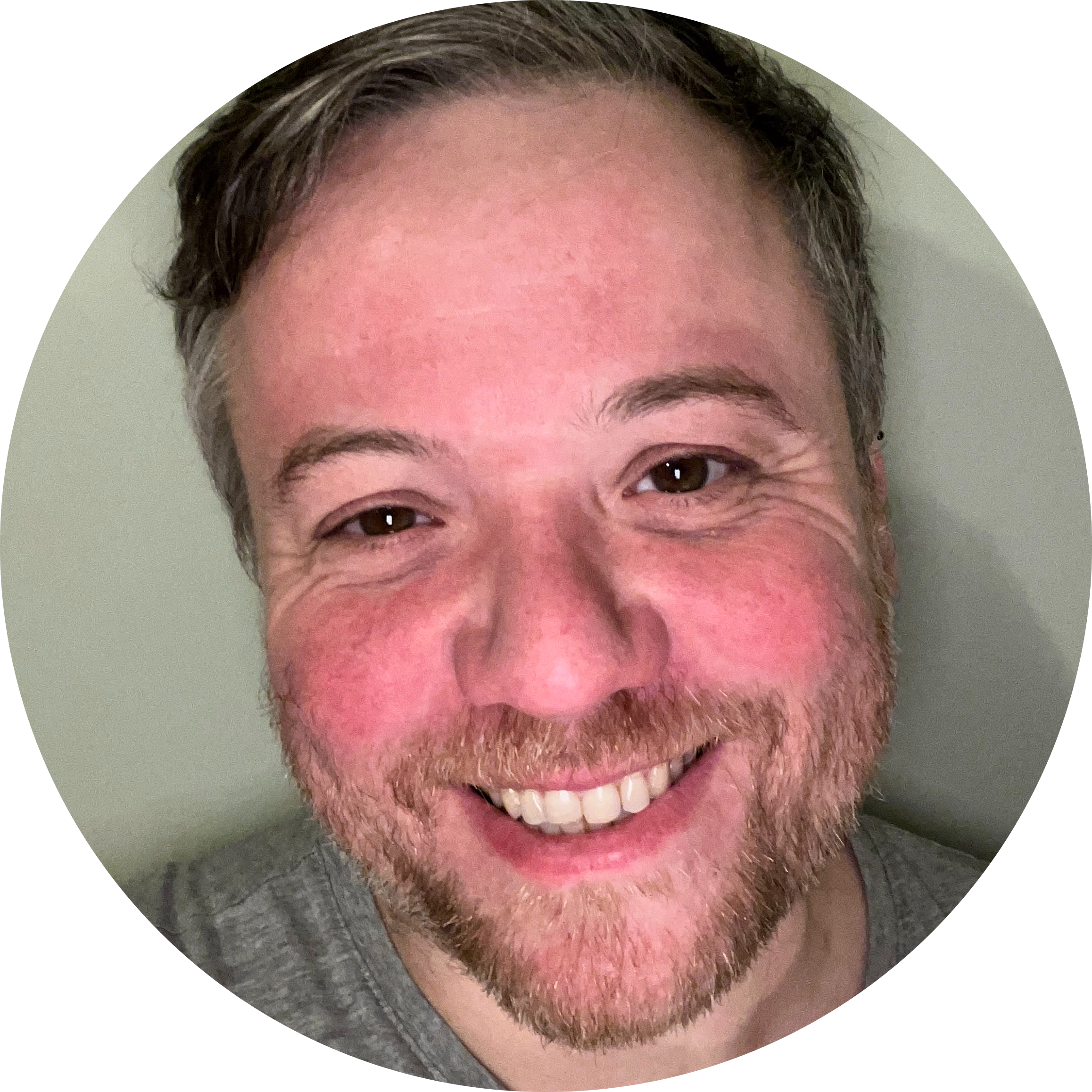 a close up selfie of me with a big smile. I have white skin, stubble and brown short ish hair.