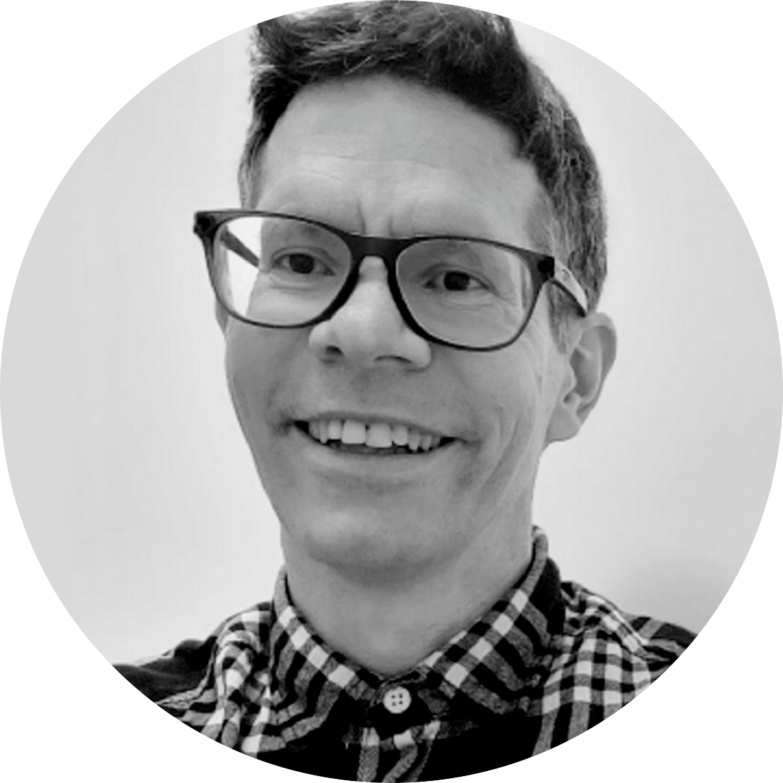 Approximate age Early 50’s , mixed background thick short curly hair with glasses. David is smiling and is wearing black and white shirt.